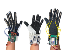 Left to right: response glove, response glove underside, control glove. Shows the wiring and components of the glove system (PCBs, 3D-printed parts, servos, flex sensors, etc.).